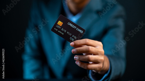Hand holding credit card focus on credit card.