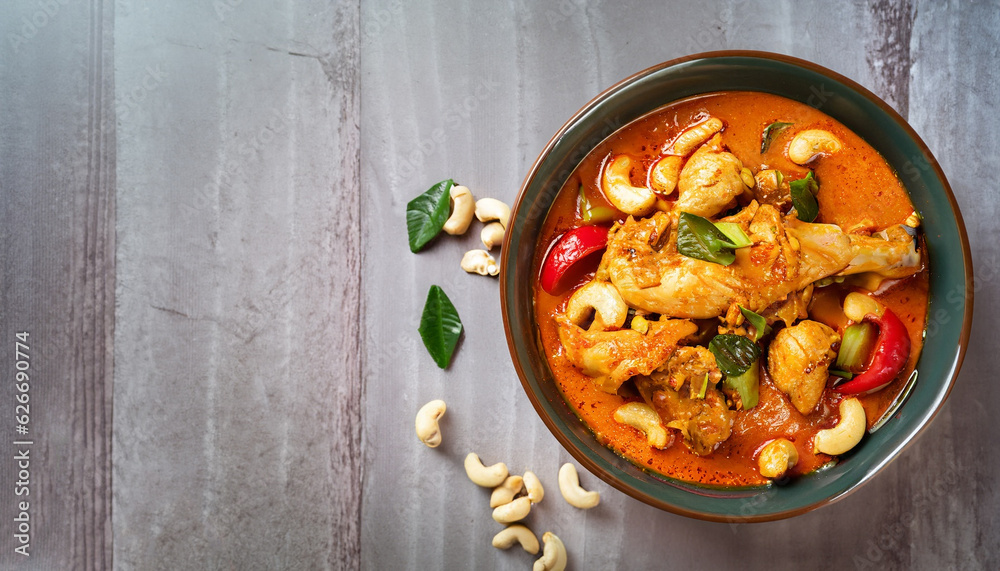 Chicken and cashew red curry, thai inspired dish overhead view with copy space Chicken and cashew red curry, thai inspired dish overhead view with copy space