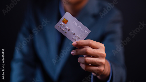 Hand holding credit card focus on credit card.