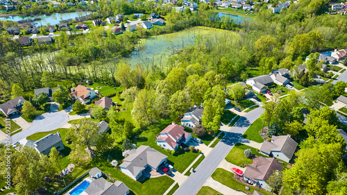 Green pond swamp separating two large neighborhoods aerial