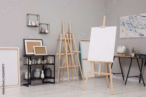 Artist's studio with easels, canvases and painting supplies