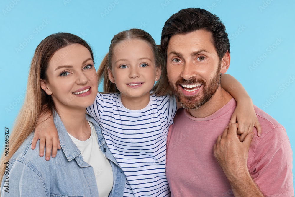 Happy family together on light blue background Happy family together on light blue background