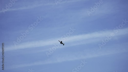 Military plane a-10 thunderbolt ii atacking enemy positiona on sunny day, slow motoin photo