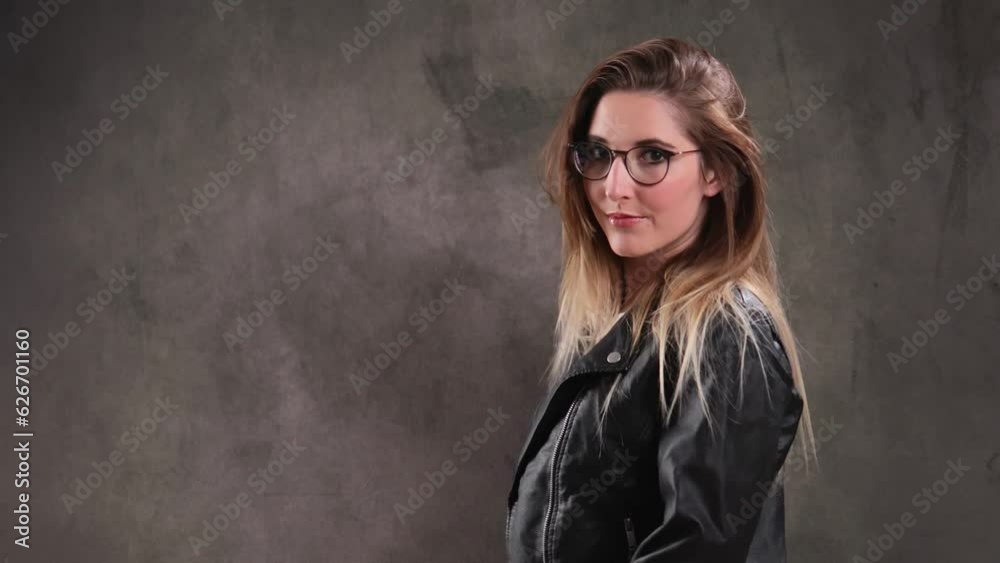 Portrait of a blonde girl posing for the camera in a studio - extreme slow motion shot Portrait of a blonde girl posing for the camera in a studio - extreme slow motion shot