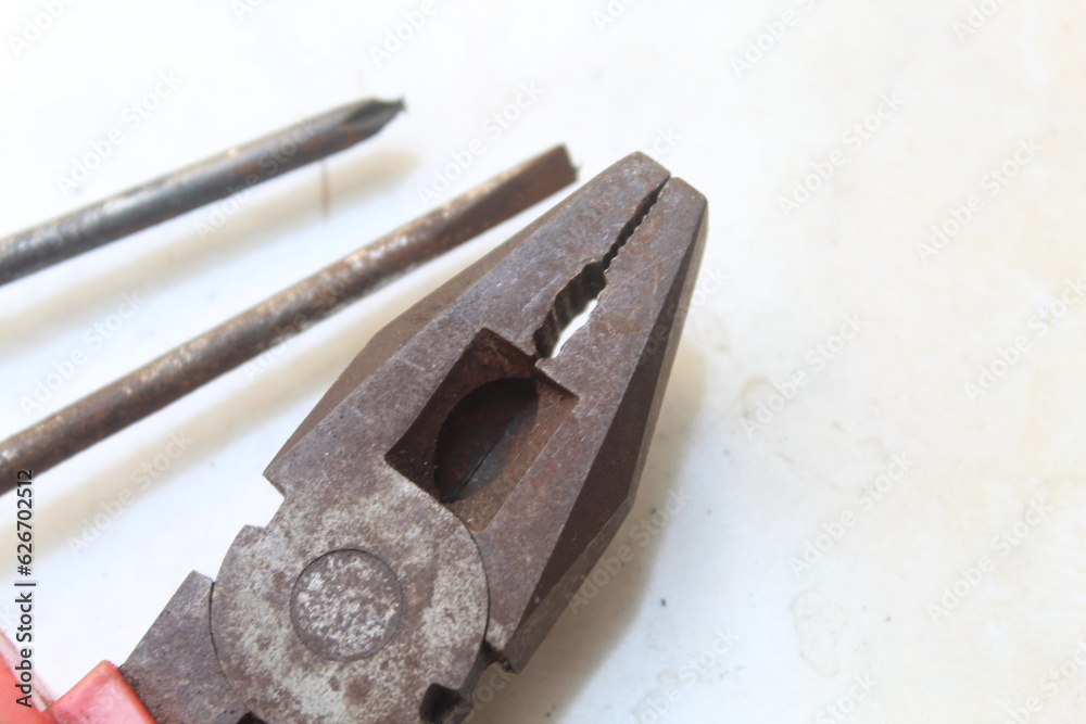 Rusty old pliers and rusty screwdriver on a white background. suitable for tool and repair themes Rusty old pliers and rusty screwdriver on a white background. suitable for tool and repair themes