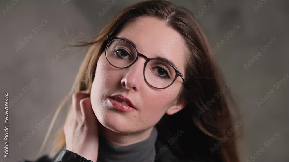 Close up of a blonde girl with a beautiful face - posing for the camera in a studio - extreme slow motion shot Close up of a blonde girl with a beautiful face - posing for the camera in a studio - extreme slow motion shot