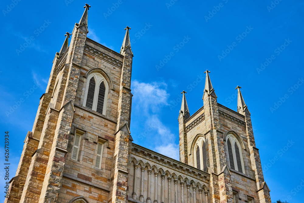 Church tower spires of St. Pauls Episcopal Church with blue sky and white cloud background