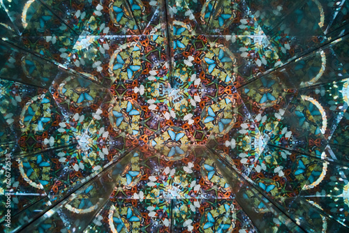 Interior of kaleidoscope with multiple multicolored butterflies