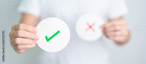 Woman show Right symbol paper. True and false, accept and rejected, evaluation, Vote, Poll, Yes or No and Survey concepts