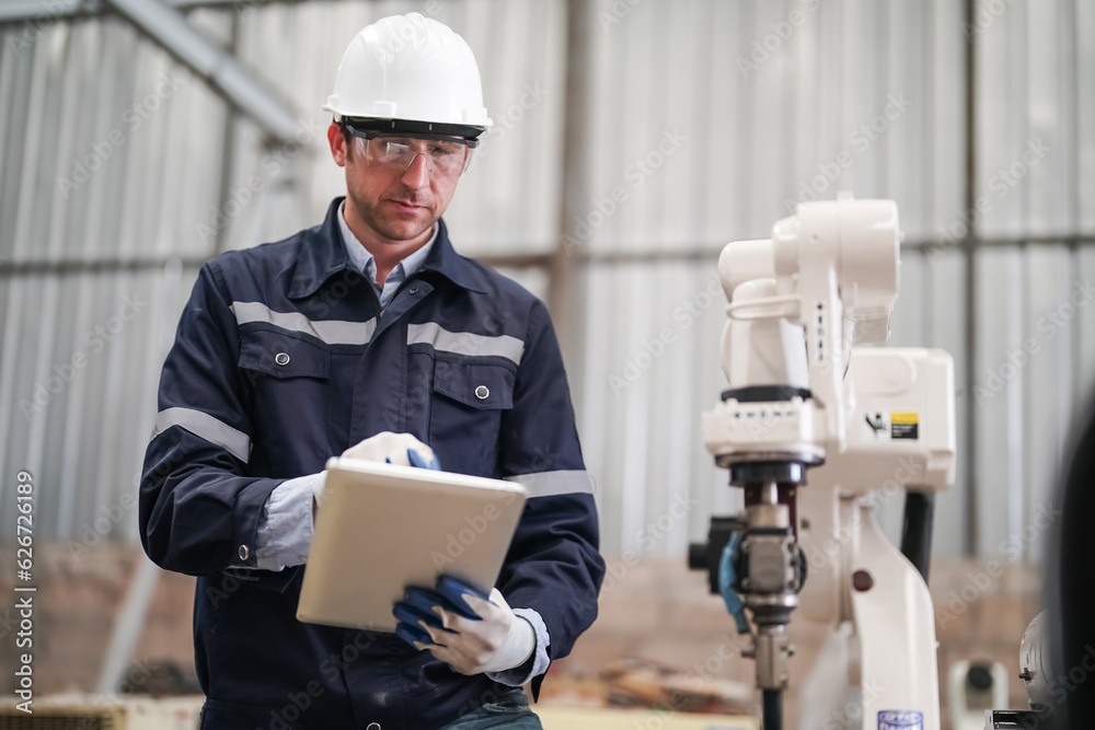 Multiracial industrial engineers working at automated AI robotic production factory, New industrial technology concept. Multiracial industrial engineers working at automated AI robotic production factory, New industrial technology concept.