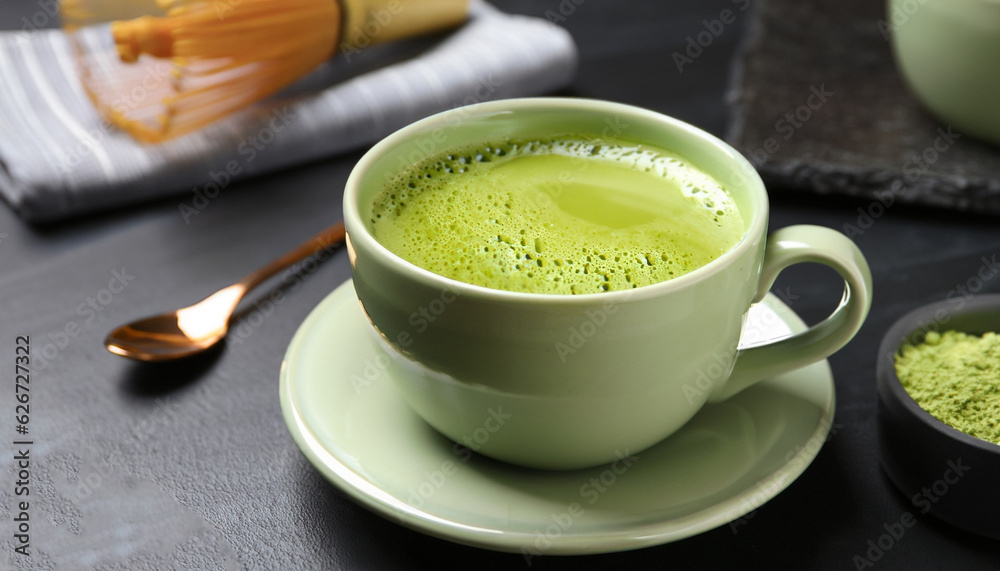 Cup of fresh matcha tea on black table, closeup Cup of fresh matcha tea on black table, closeup