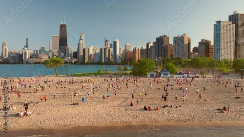 Epic shot of people playing volleyball in Chicago at a lake shore