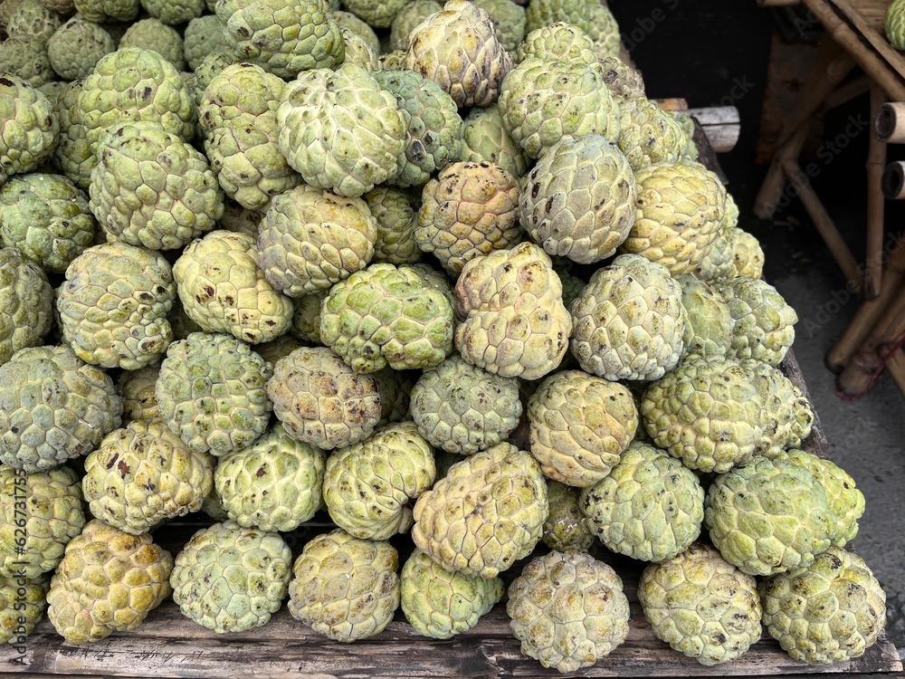 Pile of custard apple in the fruit market. Famous tropical fruit in Asia. High vitamin and nutrition. Pile of custard apple in the fruit market. Famous tropical fruit in Asia. High vitamin and nutrition.