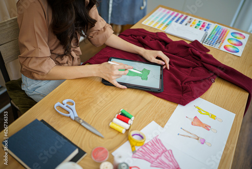 Tailor woman working in tailor shop Stylish Fashion designer tailor in workshop studio designing new collection Dressmaking and Creative.fashion collection.