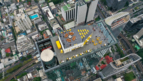 Photography Group of people or travelers enjoying and overlook a cityscape at rooftop bar of