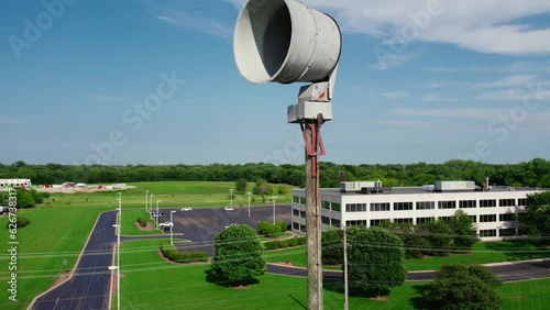 revealing Emergency Tornado Siren. seek shelter when activated. Horn pole for population of the city about emergency situations. Plainfield Illinois USA - Drone Aerial 4k photo