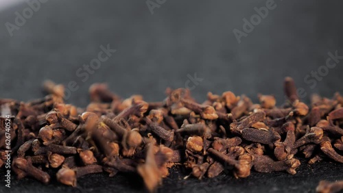 Spices dried cloves on a black background close-up for cooking. The kidneys contain the amount of essential oil which includes eugenol, acetylievgenol, as well as tannins, organic acids oleanolic acid photo