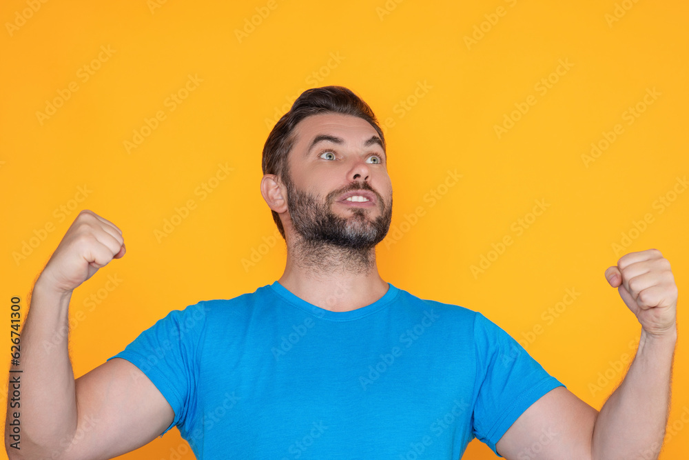 Emotional of excited man. Human reaction and emotions. Close up of excited man with facial expression. Happy and excited man doing winner gesture with arms raised, smiling and screaming for success. Emotional of excited man. Human reaction and emotions. Close up of excited man with facial expression. Happy and excited man doing winner gesture with arms raised, smiling and screaming for success.
