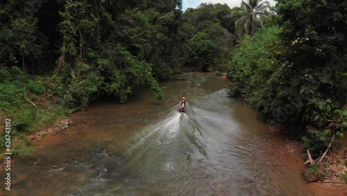 kampung sampan in a rural river beside a longhouse photo