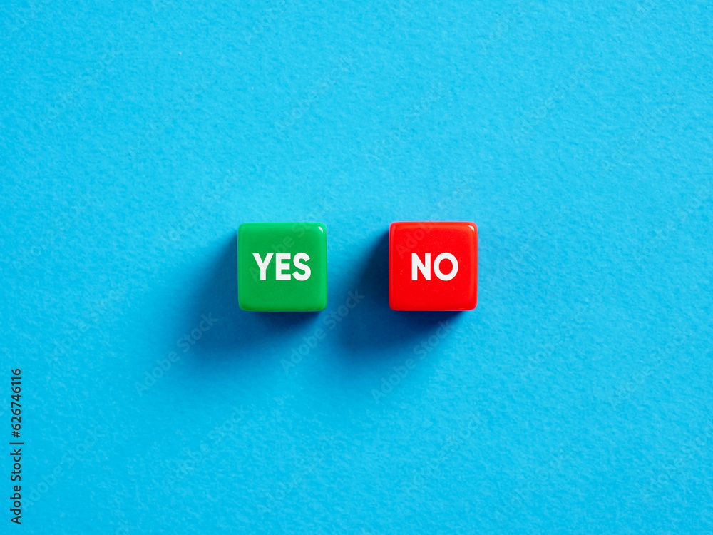 Voting yes or no. Positive or negative decision. To accept or reject. The opposite words yes or no on colorful cubes on blue background. Voting yes or no. Positive or negative decision. To accept or reject. The opposite words yes or no on colorful cubes on blue background.