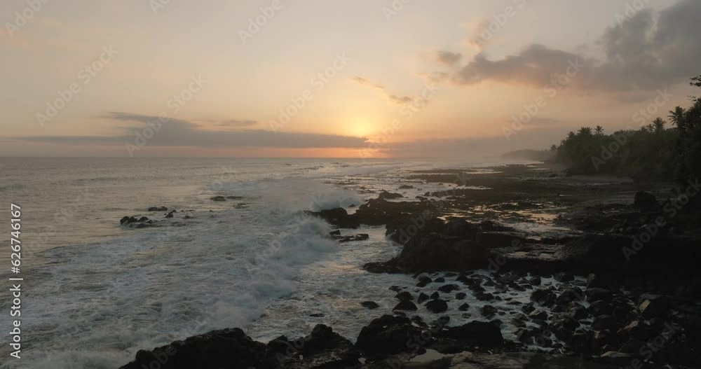Ocean waves splashing on black reef on wild beach in tropical paradise. Ocean waves splashing on black reef on wild beach in tropical paradise.