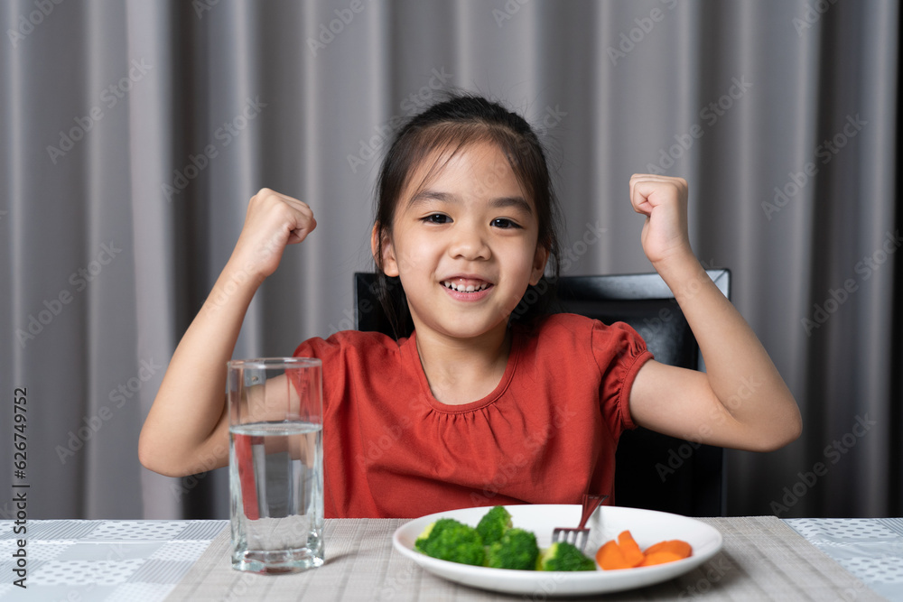 Kid shows strength of eats vegetables and nutritious food. Kid shows strength of eats vegetables and nutritious food.