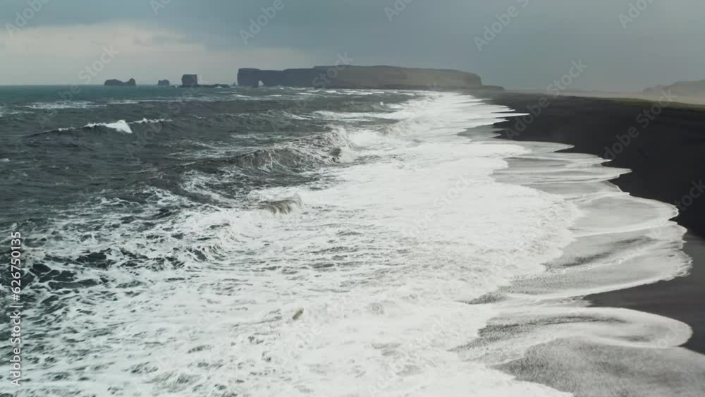 Cinematic Aerial Drone Shot of Black Sand Beach of Reynisfjara, Vik - Iceland. Waves Crushing on the Shore. Cinematic Aerial Drone Shot of Black Sand Beach of Reynisfjara, Vik - Iceland. Waves Crushing on the Shore.