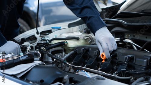 Auto machanic checking oil in car engine and car maintenance in garage. Repair service.Car Machanic.Car repair and maintenanc concept.