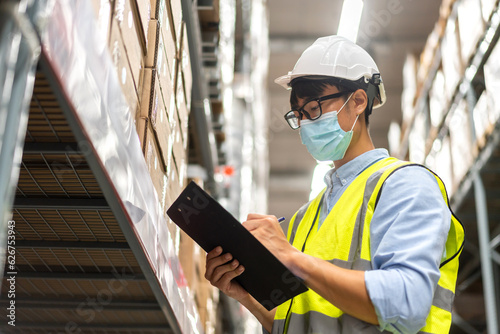 Portrait engineer worker labor asian man use tablet shipping order detail check goods and supplies on shelves with goods background inventory in factory warehouse.logistic industry and business export