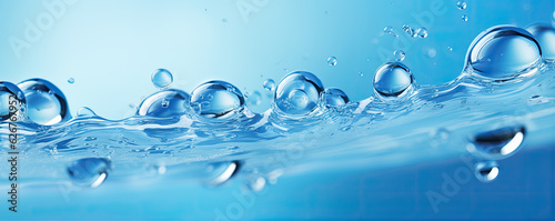 Water drops or oil bubbles on blue background. Droplets panorama picture.