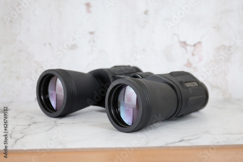 Binoculars on an isolated white background. Zoom binocular for astronomy observation or military 