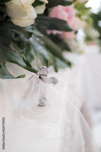 Coffin nails cross with a beautiful arrangement of pink flowers on the lid at a funeral ceremony and farewell