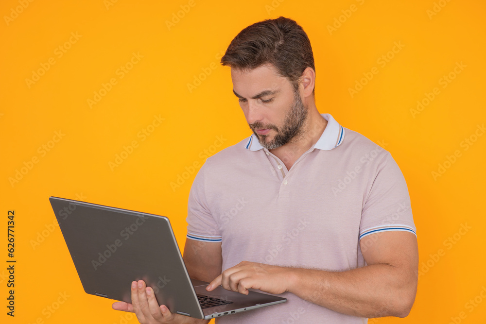 Business man using laptop. Male businessman worker watch video on computer laptop. Serious man hold laptop computer. Caucasian male worker in glasses work with laptop, studio isolated portrait.