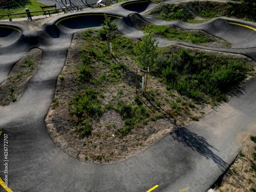 bike path in the car park Pumping moving up and down is used instead of pedaling and bouncing to move bicycles, scooters, skateboards and inline skates along large pumptrack track photo