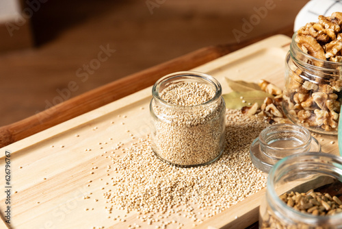 small jar with quinoa on rustic table top view. Healthy food and snack.