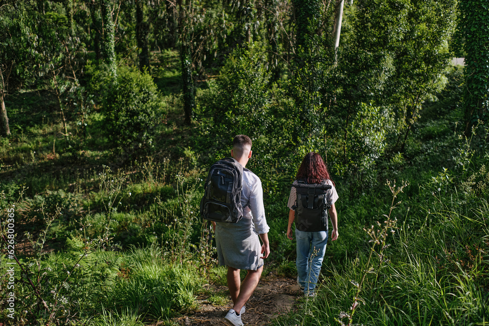 Man and woman exploring forest at sunny day Man and woman exploring forest at sunny day