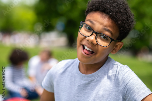 Smiling curly-haired african american teen looking happy