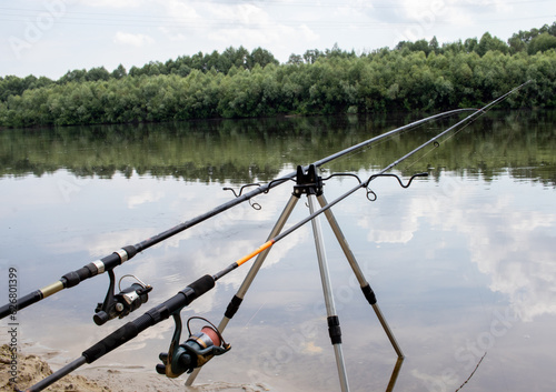 fishing rods on the background of the river with nature