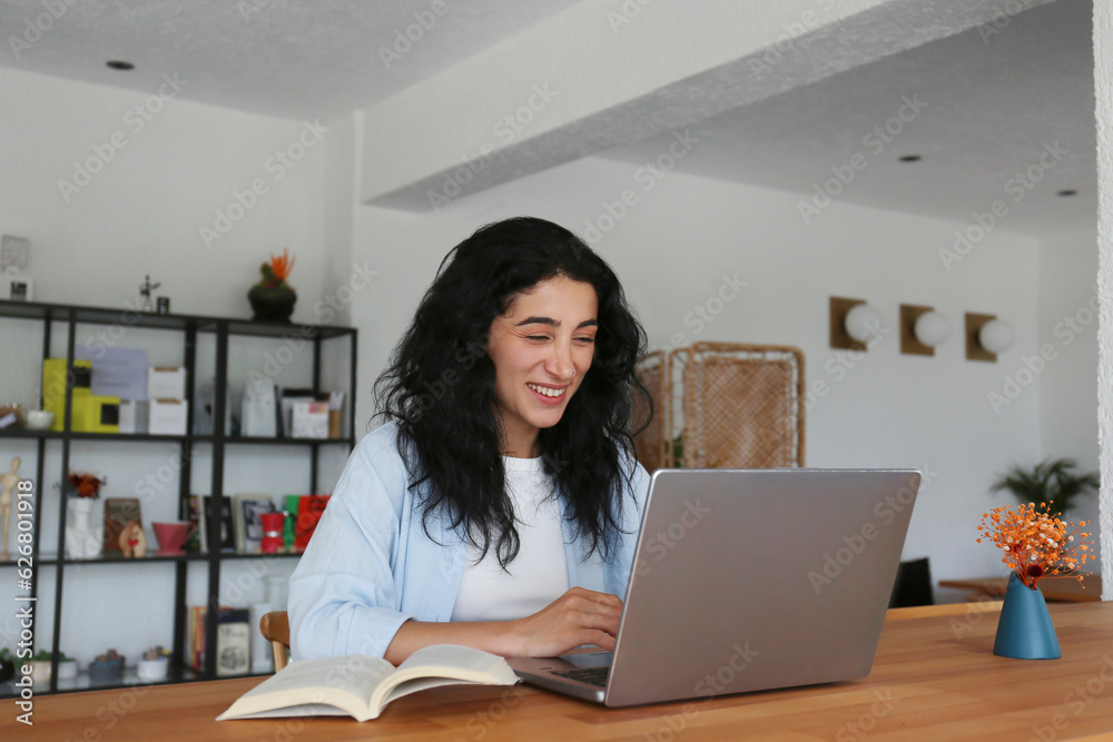Smiling woman studying with laptop at cafe Smiling woman studying with laptop at cafe