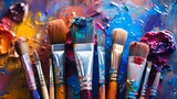 Colorful paint brush splashes on canvas. Row of artist paintbrushes closeup on artistic canvas