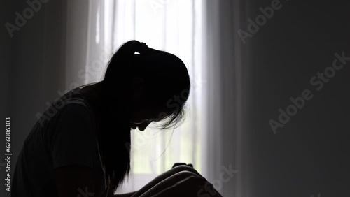 silhouette of a sad woman in the dark domestic violence Family problems. Stress. Violence. Depression and suicide concept. photo