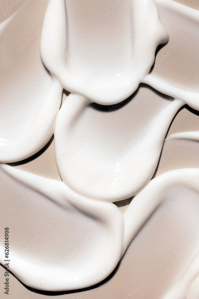 cosmetic smears of creamy texture on a beige background