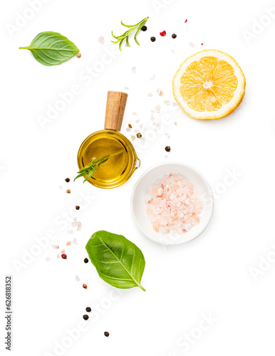 Various herbs and spices, oil in white bowl and half of lemon isolated. © Tatyana Sidyukova