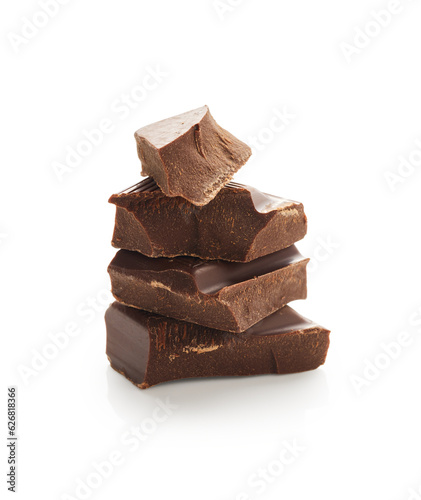 Stack of broken milk chocolate bar pieces isolated on white background