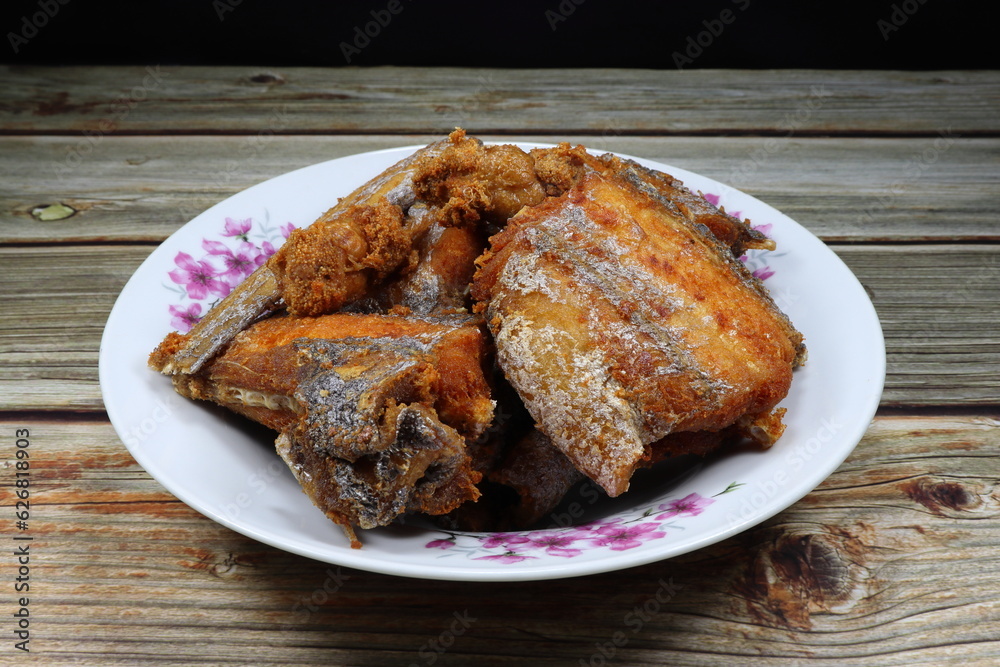 Pile of deep fried Cutlass fish (Largehead Hairtail) serving on the plate. Famous crispy and crunchy seafood menu in Asia restaurant. Pile of deep fried Cutlass fish (Largehead Hairtail) serving on the plate. Famous crispy and crunchy seafood menu in Asia restaurant.