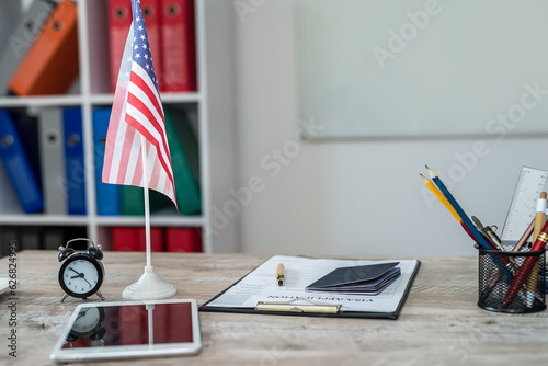 american passport with united states national flag on front desk with copy space.