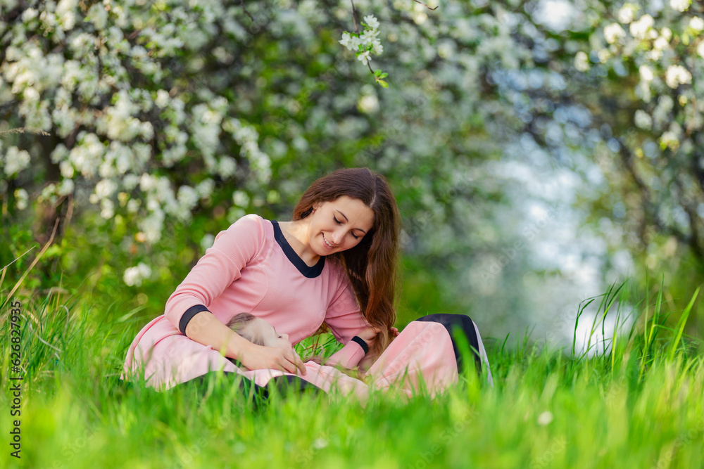 mother and daughter sit outdoors in a blooming garden mother and daughter sit outdoors in a blooming garden