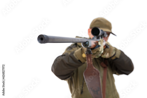 Defocused portrait of fifty-year-old man in hunting uniform aiming a gun with focus on the end of the rifle, isolated on white background. Mature hunter shoots with a rifle to the side.