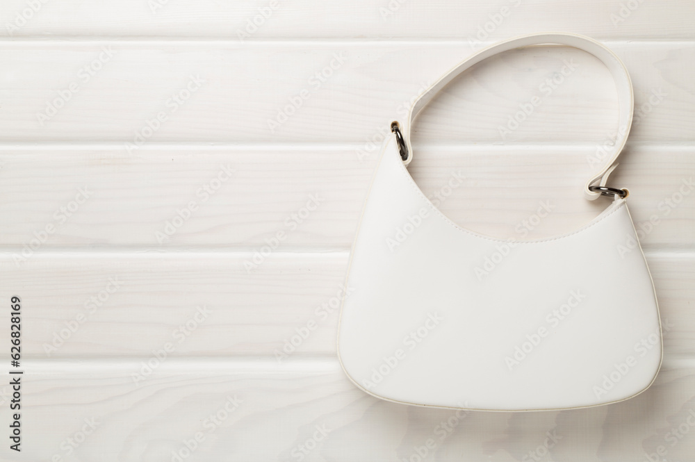 Trendy woman bag on wooden background, top view Trendy woman bag on wooden background, top view