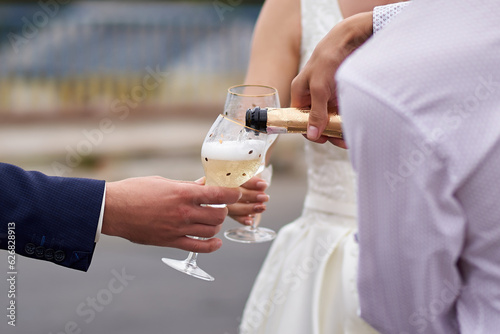 Close-up of champagne being poured into glasses